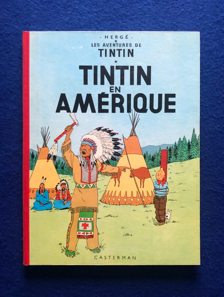 Réédition de Tintin en Amérique de 1961, 4ème plat B30, dos Rouge, page de garde bleu claire, imprimé en Belgique.